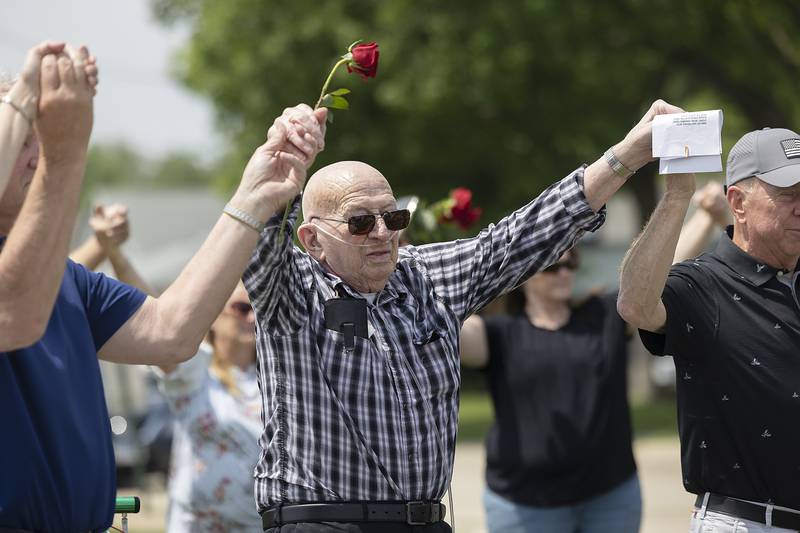 Robert Hoak of Polo joins hands Sunday, June 8, 2025, at the end of the legacy stone dedication. Hoak had a stone dedicated in his honor.