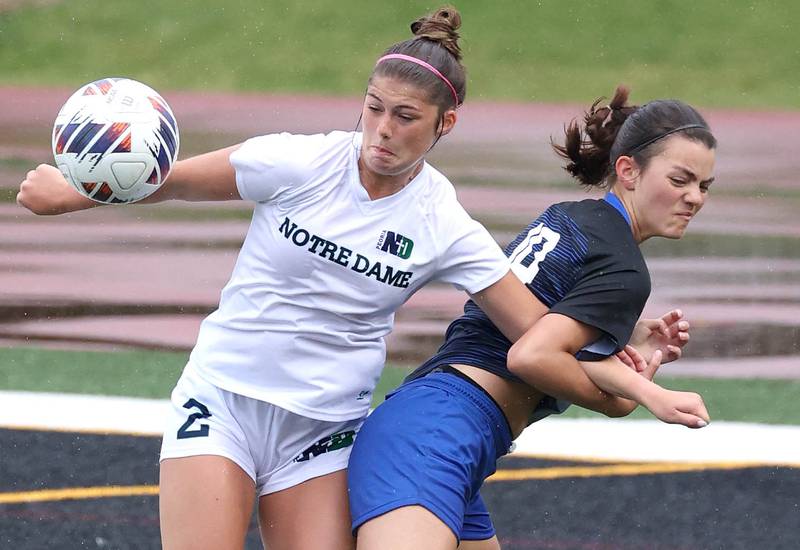 Burlington Central's Lauren Meyer (right) tries to hold off Peoria Notre Dame's Addison Bellamy during their third place game Saturday, June 1, 2024, at the IHSA Class 2A state soccer finals at North Central College in Naperville.