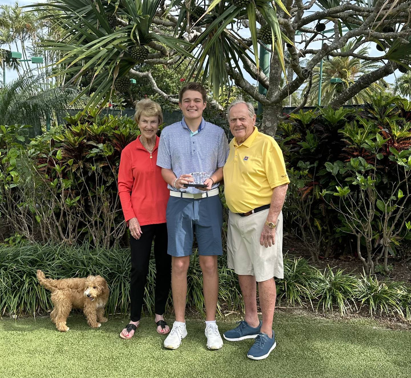 Liam Lodding is presented with a crystal bear from Barbara and Jack Nicklaus. Lodding was honored with the Golden Bear Award for the most money raised by a single youth.