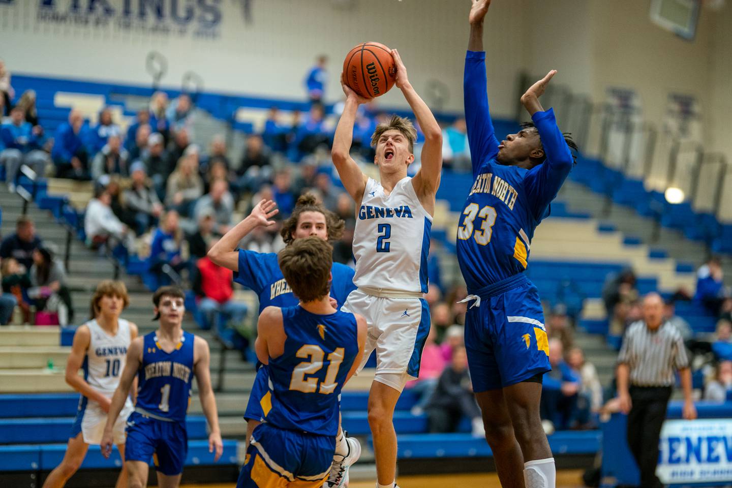 Geneva’s Michael Lawrence (2) shoots the post against Wheaton North's Jalen Crues (33) and Connor Speers (21) during a basketball game at Geneva High School on Friday, Jan 6, 2023.