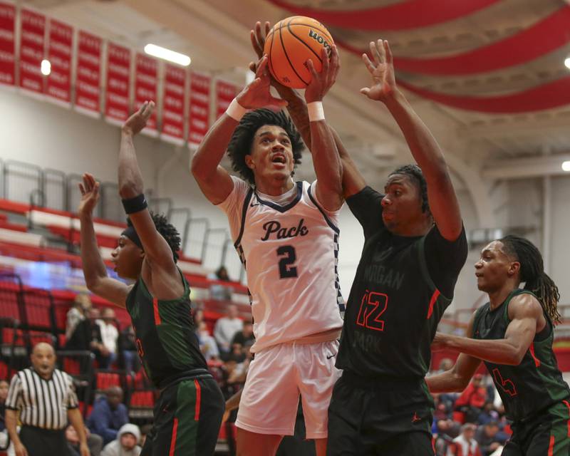 Oswego East's Jacsen Tucker (2) is fouled on a shot during their Hinsdale Central Holiday Classic basketball game between Morgan Park at Oswego East Saturday, Dec 27, 2025 in Hinsdale.