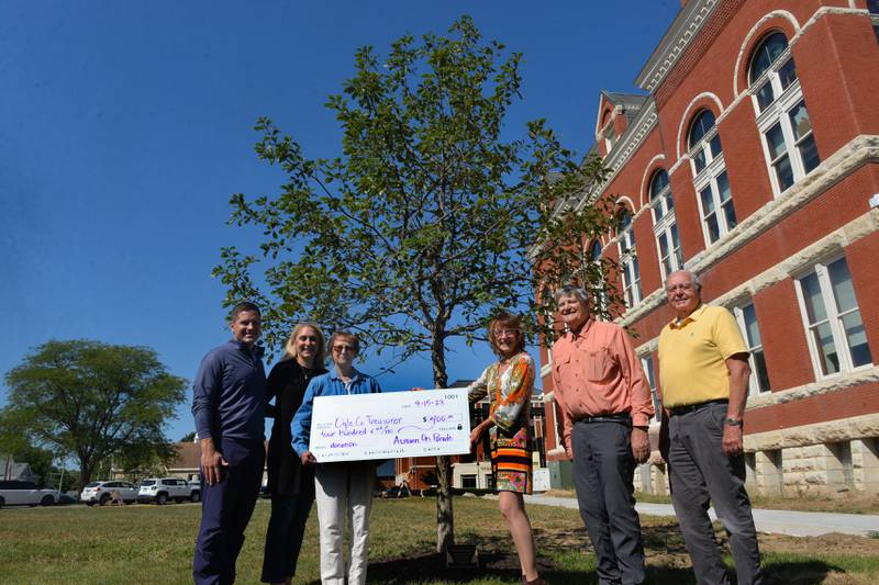 A white oak was planted near the southeast corner of the Ogle County Courthouse in memory of Dave Stenger on Friday, Sept. 15, 2023. The Autumn on Parade Committe donated $400 for the tree, dedicated in Stenger's name. Pictured, left to right, are: Jeremy Stenger, Melissa Mudge, Shirley Stenger, Debbie Dickson, presiden of the Autumn on Parade Committee, and Don Griffin and John Finfrock, Ogle County Board members.