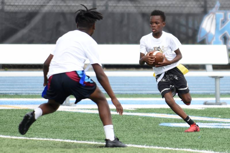 Major Whiteside, 9, of Kankakee, right, looks for a way around Kylen Brooks, 12, also of Kankakee, during a game of 7-on-7 at the sixth annual Jonathan Ward Skills Camp at Kankakee High School Saturday, June 14, 2025.