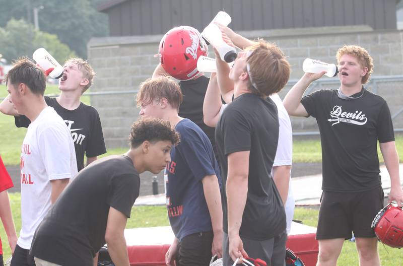 Members of the Hall high School football team take a water break during camp on Thursday, July 24, 2025 at Hall High School.