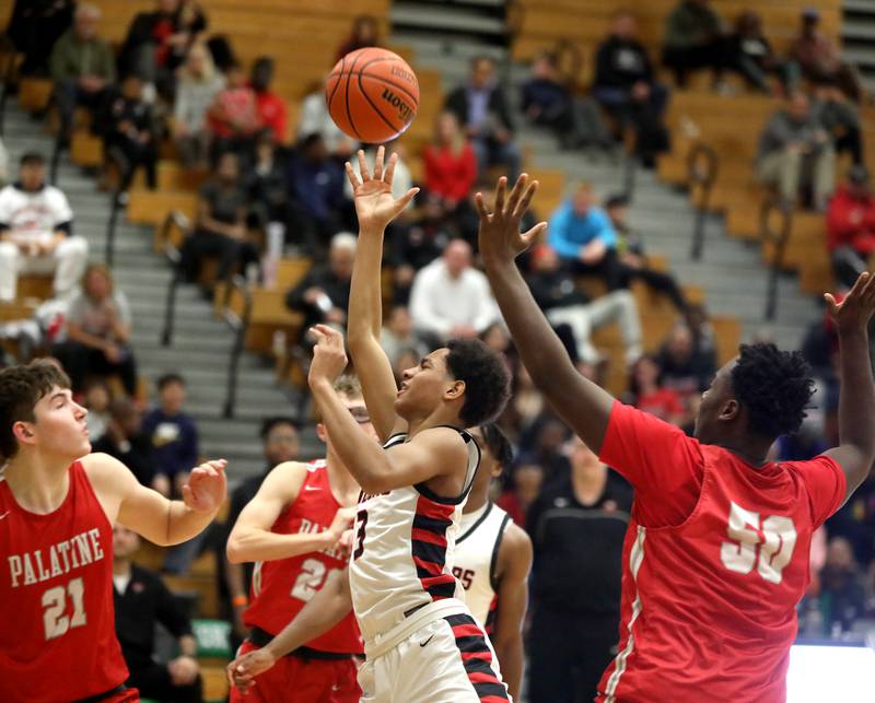 Bolingbrook’s Davion Thompson (center) attempts a shot during the Jack Tosh Holiday Classic semifinals against Palatine at York High School in Elmhurst on Friday, Dec. 29, 2023.