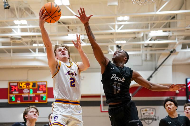 Downers Grove North's Jack Romsey (2) shoots the ball in the post against Oswego East's Reginald McWaine (11) during a Batavia Night of Hoops Basketball game at Batavia High School on Saturday, Jan. 25, 2025.