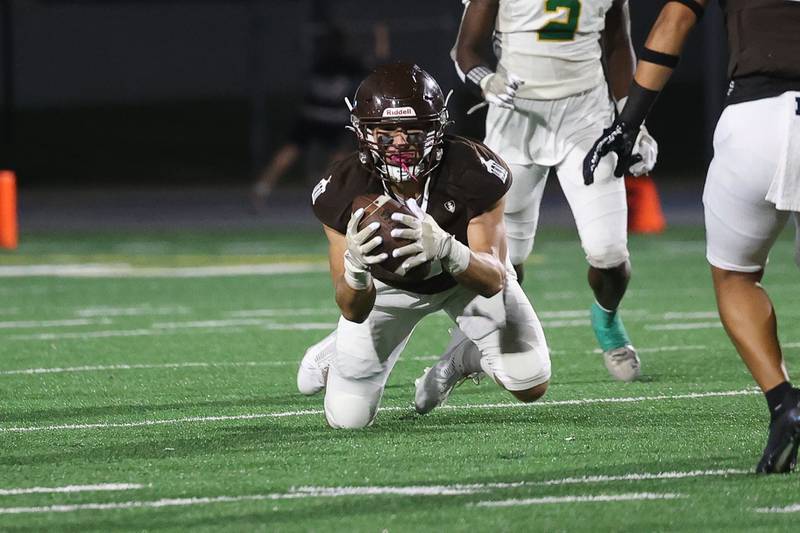 Joliet Catholic’s Zak Beitler gets under the deflected pass for an interception against Providence on Friday, Sept. 1, 2023 Joliet Memorial Stadium.