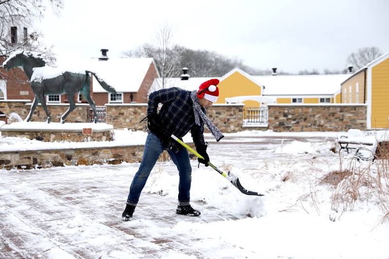 Andre Polozov shovels a walkway on Friday, Dec. 20. 2024 at St. James Farm Forest Preserve in Warrenville.