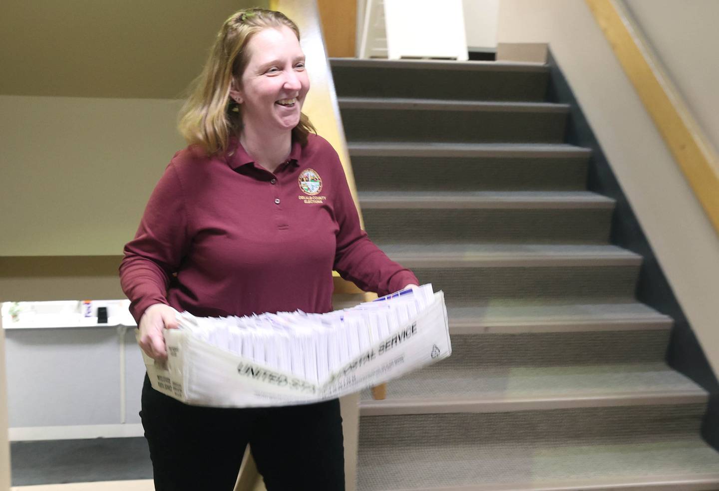 Jessica Rugerio, chief deputy of elections, brings up more vote-by-mail ballots to be put into envelopes Wednesday, Feb. 22, 2023, in the DeKalb County Administration Building in Sycamore.