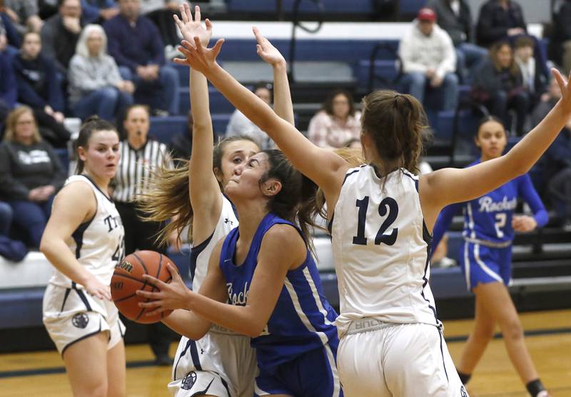 Burlington Central's Samantha Origel splits the defense of Cary-Grove's Sam Skerl and Cary-Grove's Payton Seibert to shoot a shot during a Fox Valley Conference girls basketball game Friday Jan. 6, 2023, at Cary-Grove High School in Cary.
