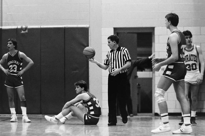(From left) L-P's Mike Emerick, John Happ, and Ottawa's Dewey Gould wait for a referee to make a call during the Regional title game on Saturday, Feb. 28, 1986 at La Salle-Peru Township High School.