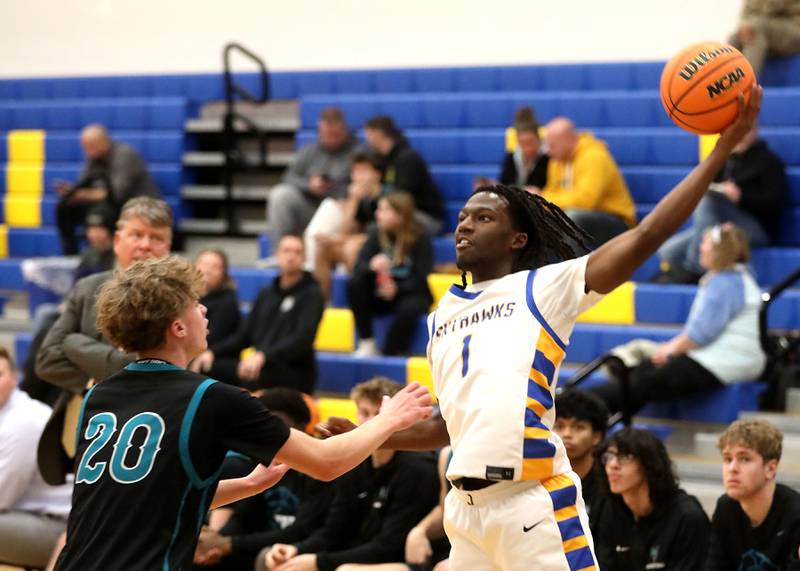 Johnsburg's Jarrel Albea (right) grabs a pass as he is guarded by Woodstock North's Ethan Richardson during a Kishwaukee River Conference boys basketball game on Monday, Dec. 15, 2025, at Johnsburg High School.