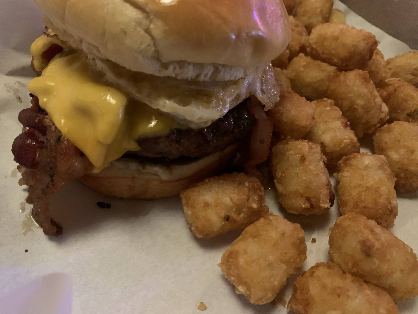 The Breakfast All-Day Steak Burger with tater tots on the side at Cattleman's Burger and Brew in Algonquin.