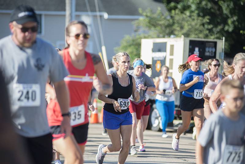 Runners in the 2022 Regan Run head north on Hennepin Avenue near the start of the 5K. The race returned to it’s original course on Saturday, July 2, 2022 after taking a cover hiatus in 2020 and a different route due to construction in 2021.