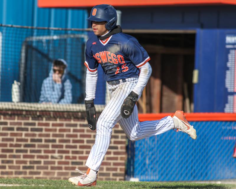 Oswego's Kam Jenkins (25) runs in for a score during baseball game between Plainfield South at Oswego on Monday, April 14, 2025 in Oswego.