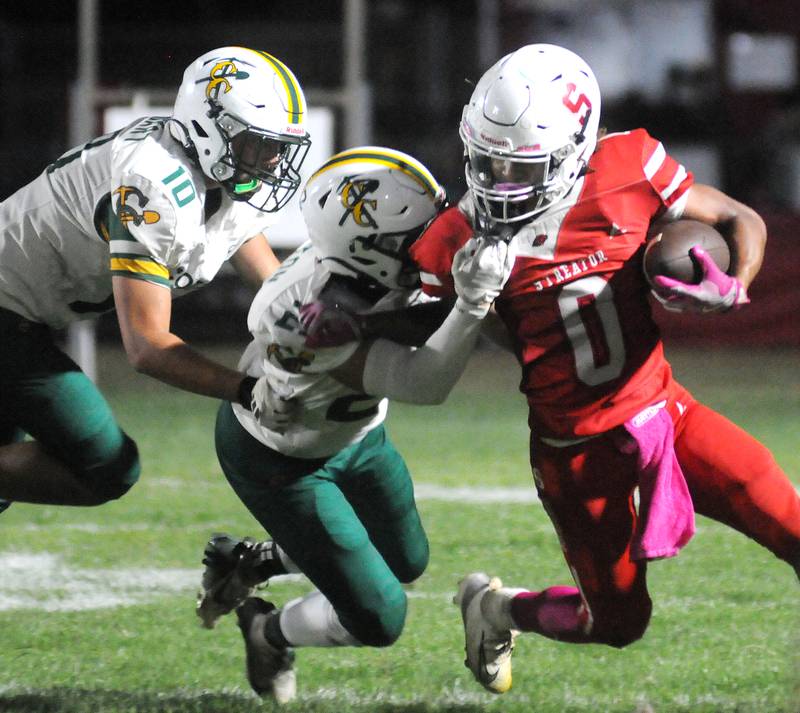 Coal City's Drake Stewart (10) and Noah Huston tackle Streator's Layzeric Moton (0) on Friday, Sept. 19, 2025 at Doug Dieken Stadium.