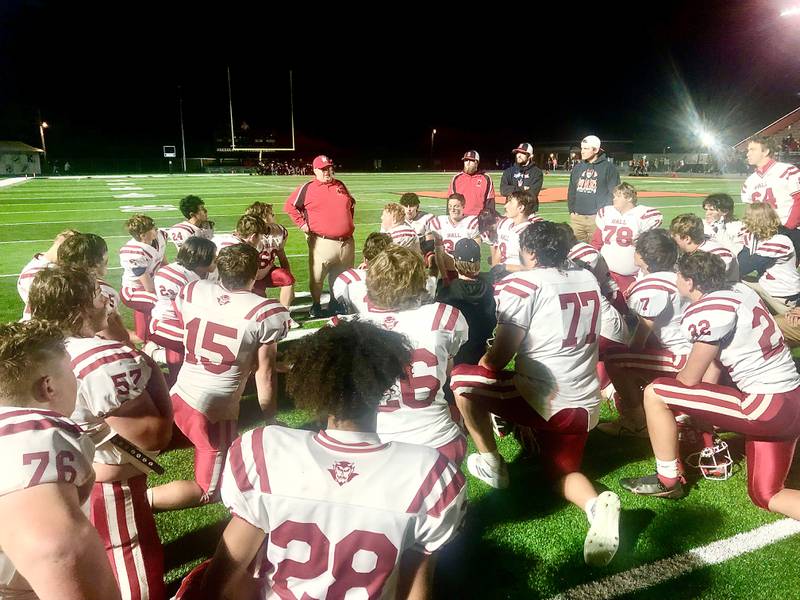 Hall coach Randy Tieman gathers his troops following the Red Devils 26-15 win at Kewanee Friday night. Hall improved to 3-3 with the win with an eye on the playoffs.