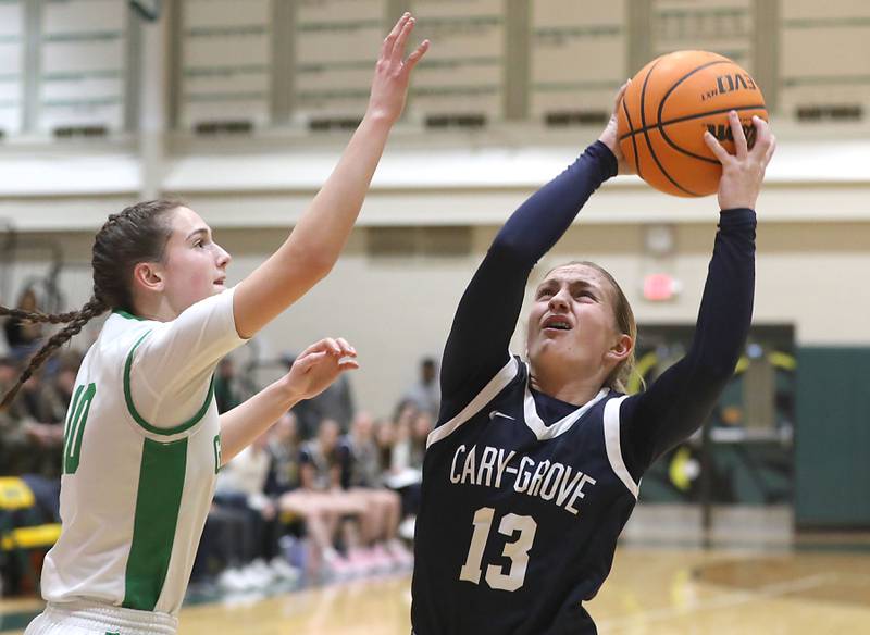 Cary-Grove's Malaina Kurth grabs a rebound in front of Crystal Lake South's Mallory Glover during a Fox Valley Conference girls basketball game on Friday, Jan. 23, 2026, at Crystal Lake South High School.