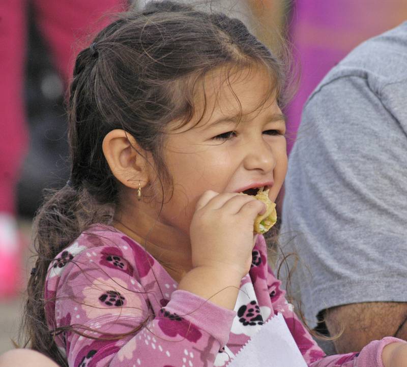 Rafaela Alvarado of Rock Falls chows on tacos at  the Taco Throwdown Events Sponsored by Rock Falls Tourism. Event at RB&W District September 27th, 2024.