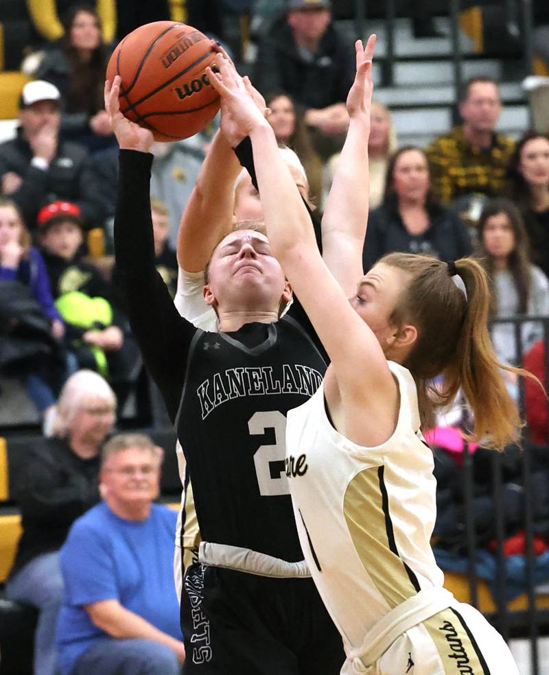 Kaneland's Kailey Plank and Sycamore's Mallory Armstrong go after a rebound during the Class 3A regional final game Friday, Feb. 17, 2023, at Sycamore High School.