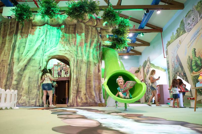 Adelaide Martyka, 3, of Wilmington, arrives at the bottom of the slide with a crown and shield in hand at the Exploration Station's new Storybook Forest exhibit on Monday, June 23, 2025, during its grand opening event.