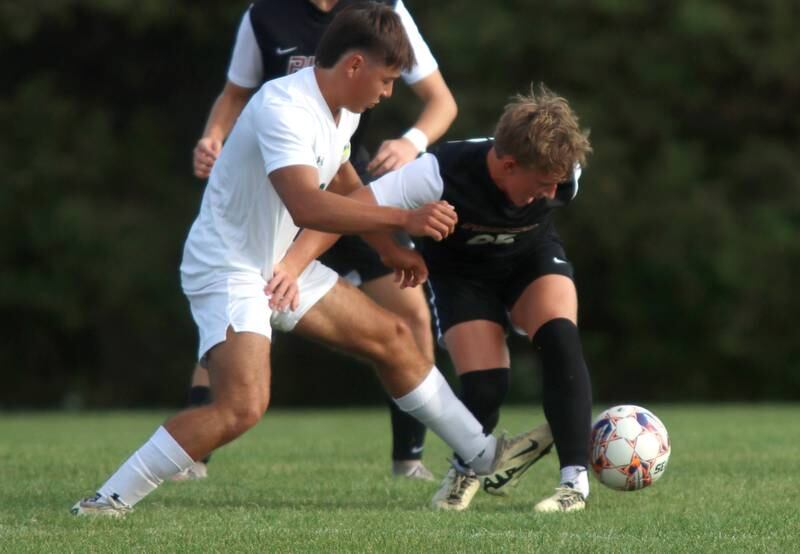 Crystal Lake South’s Hayden Stone battles Prairie Ridge’s Jensen Schroeder, right, in varsity soccer on Thursday, Sept. 19, 2024, at Prairie Ridge High School in Crystal Lake.