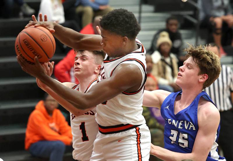 DeKalb’s Davon Grant and Jackson Kees go after a rebound Thursday Dec. 28, 2023, during their second round game in the 96th Chuck Dayton Classic boys basketball tournament at DeKalb High School.