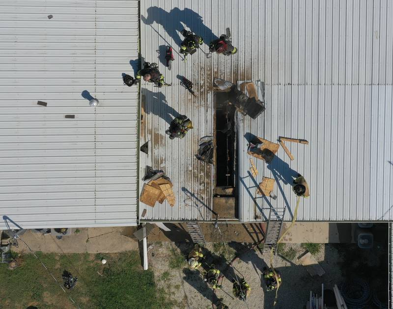 An aerial view of firefighters on top of a roof at Grassers Heating and Plumbing on Wednesday, Sept. 17, 2025 in McNabb. The fire began shortly before 10a.m. A Mutual Aid Box Alarm System (MABAS) was elevated to the fourth-alarm. No one was injured in the fire. Fire departments from McNabb, Peru, Utica, Henry, Ladd, Hennepin, Granville, Oglesby, Spring Valley, Leonore, Troy Grove, Seatonville, Wenona, Standard, Lacon-Sparland, Bureau and Tonica all responded to the scene. Firefighters left the scene at 11:30a.m.