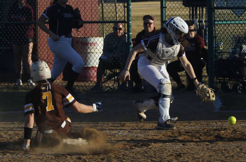Marengo's Abby Balmes tries to grab the ball as Jacobs' Talia Disilvio scores a run during a nonconference softball game on Monday, March 9, 2026, at Marengo High School.