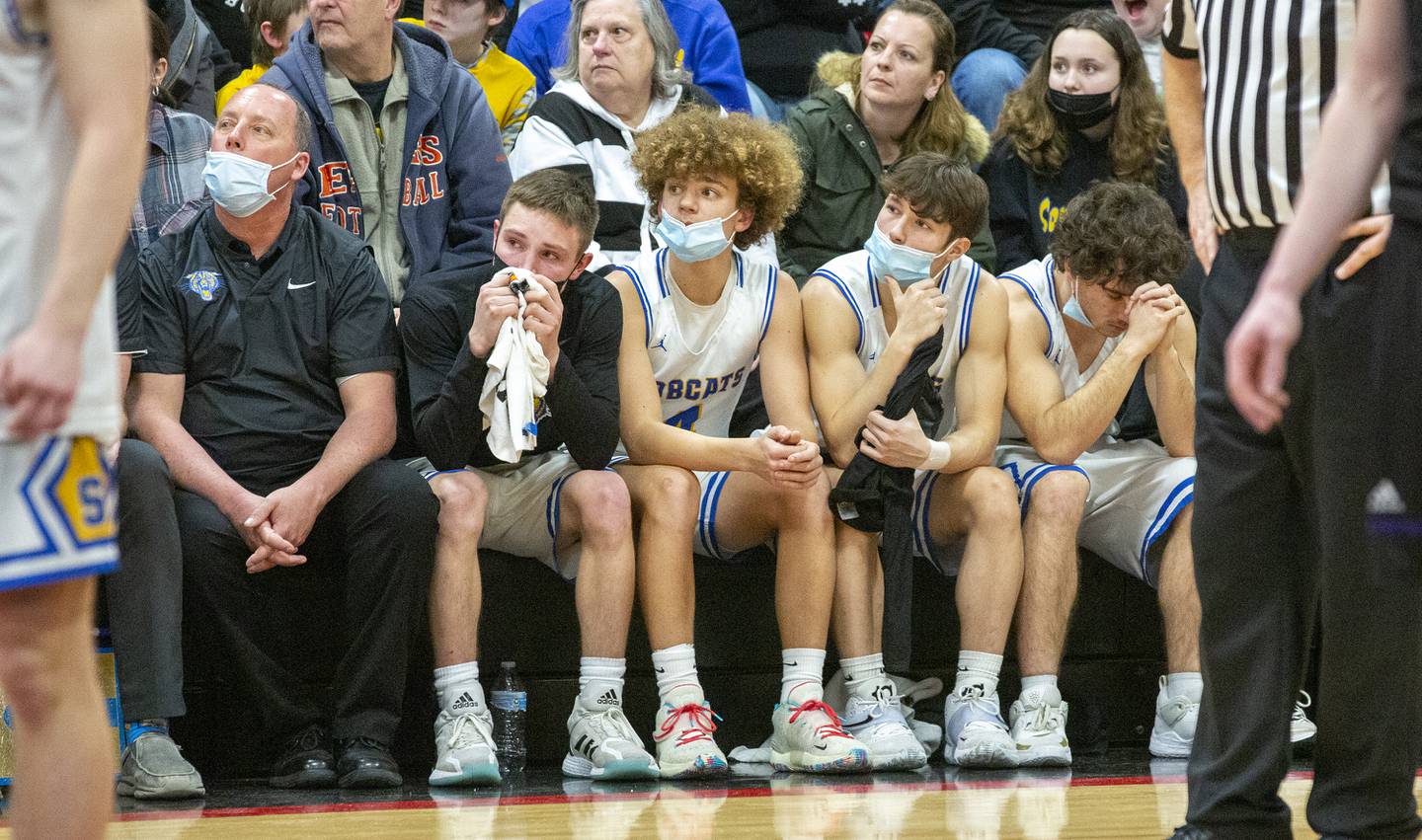 Members of the Somonauk boys basketball team watch the final seconds from the bench in the Class 1A Indian Creek Regional title game on Friday, Feb. 25, 2022, at Indian Creek High School in Shabbona.