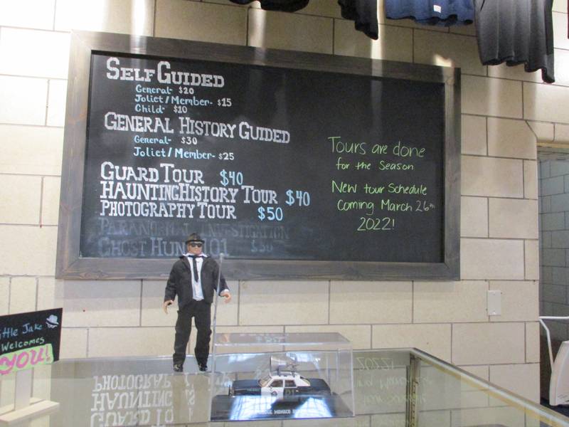 Chalkboard in the Visitors Center at the Old Joliet Prison lists prison tours and prices.