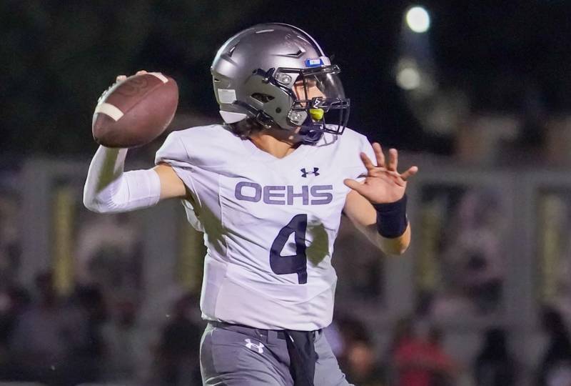 Oswego East's Niko Villacci (4) drops back in the pocket and looks downfield against Waubonsie Valley during a football game at Waubonsie Valley High School in Aurora on Friday, Aug. 25, 2023.