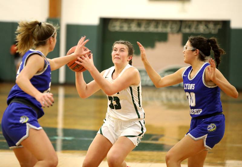 Glenbard West’s Makenna Yeager (center) looks for a shot during a game against Lyons Township in Glen Ellyn on Tuesday, Dec. 12, 2023.