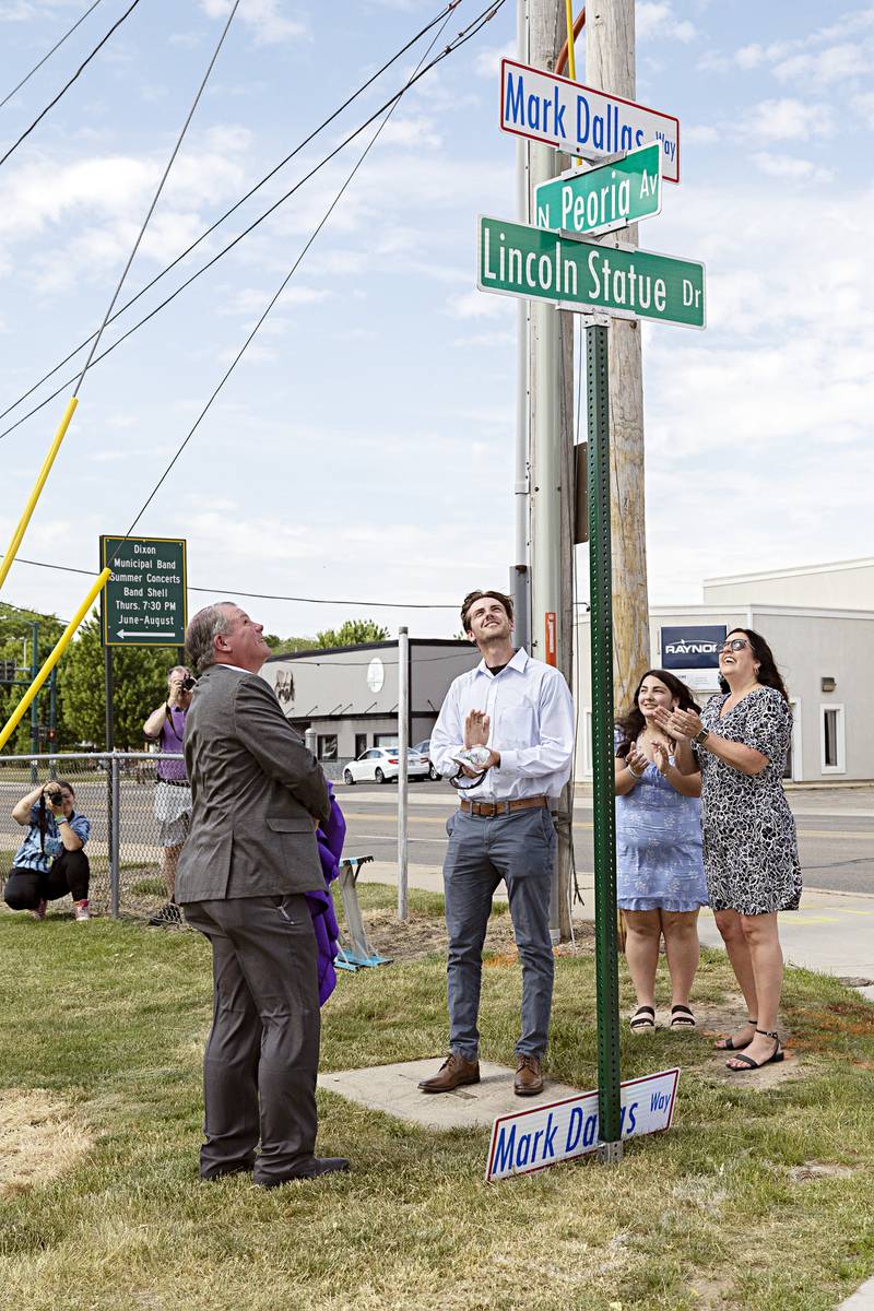 Mark Dallas looks up at a sign designating the street in front Dixon High School as “Mark Dallas Way” during a ceremony on Tuesday, May 30, 2023.