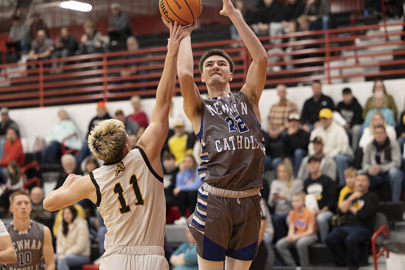Newman’s Asher Ernst puts up a shot over Riverdale’s Brady Junis Tuesday, Dec. 30, 2025, in the final of the boys Cliff Warkins Basketball Tournament at Erie High School.