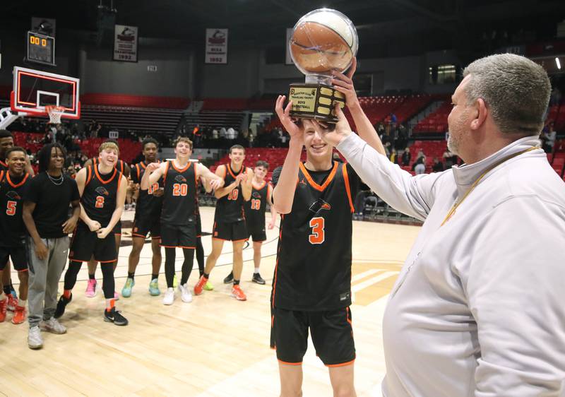 DeKalb's Alex Streb accepts the trophy after their win over Sycamore Friday, Jan. 31, 2025, in the FNBO Challenge in the Convocation Center at Northern Illinois University in DeKalb.