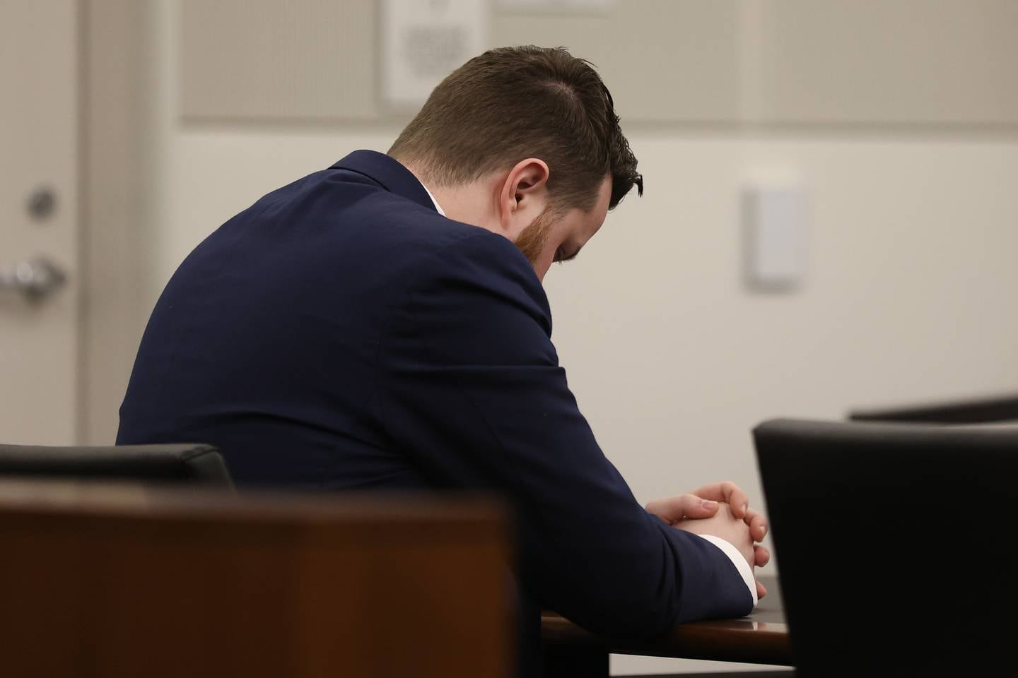 Defendant Sean Woulfe sat with his head down throughout most of the closing arguments on Monday. Sean Woulfe, 29, is charge with reckless homicide of Lindsey Schmidt, 29, and her three sons, Owen, 6, Weston, 4, and Kaleb, 1. Monday, Mar. 28, 2022, in Joliet.