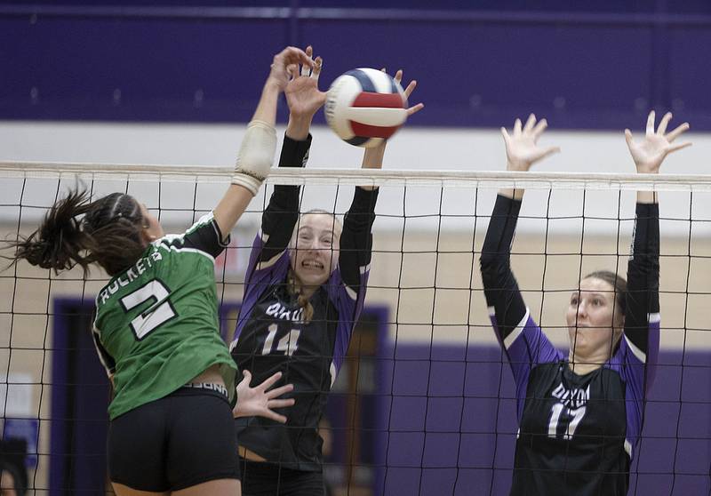 Dixon’s Leah Carlson (left) and Lucy Feick work for the block against Rock Falls Thursday, Sept. 18, 2025.