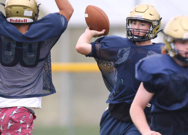 A Hiawatha quarterback throws the ball over a pass rusher during practice Wednesday, August 9, 2023, at the school in Kirkland.