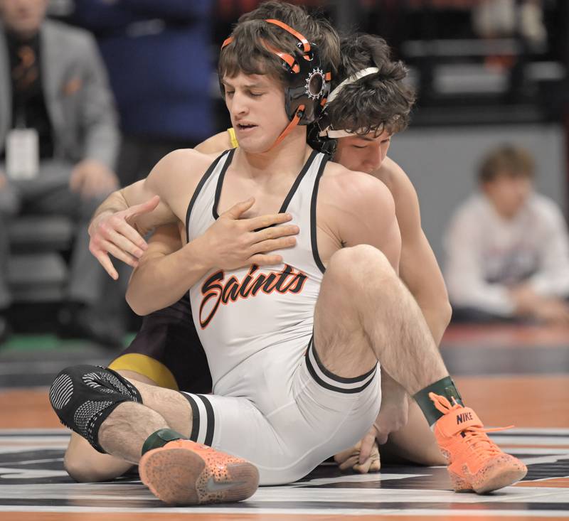 St. Charles East’s Dom Munaretto battles Montini’s Allen Woo to victory in the Class 3A 120-pound match at the boys IHSA wrestling finals at State Farm Center in Champaign on Saturday, Feb. 21, 2026.