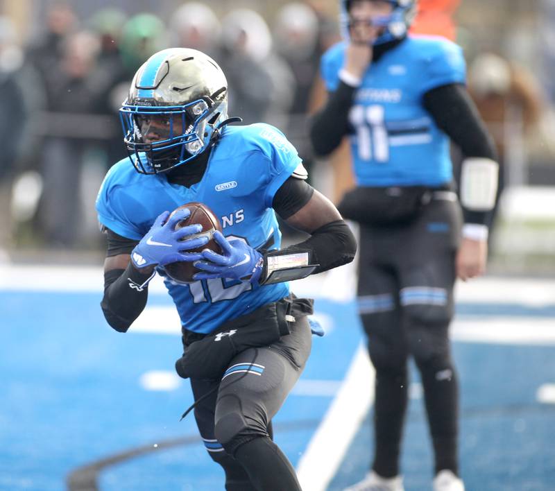St. Francis’ Amari Head carries the ball during their Class 4A semifinal game against Providence in Wheaton on Friday, Nov. 19. 2022.