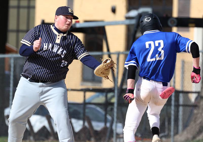 Hiawatha’s Logan Brush has to tag Hinckley-Big Rock's Skyler Janeski after the throw pulled him off the base Tuesday, April 29, 2025, during their game at Hiawatha High School in Kirkland.