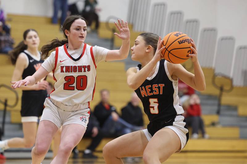 Lincoln-Way West’s Ava Tisch works the ball against Lincoln-Way Central’s Aubrey Birmingham on Tuesday, Jan 28, 2025 in New Lenox.