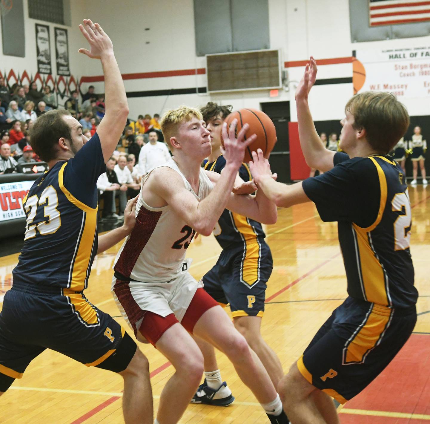 Fulton's Ethan Price (23) is surrounded by Polo defenders Cayden Webster (left) Carter Merdian (behind )and Carson Jones (right) as he drives to the basket during a Friday, Jan. 13 game on the Stan Borgman Court in Fulton.
