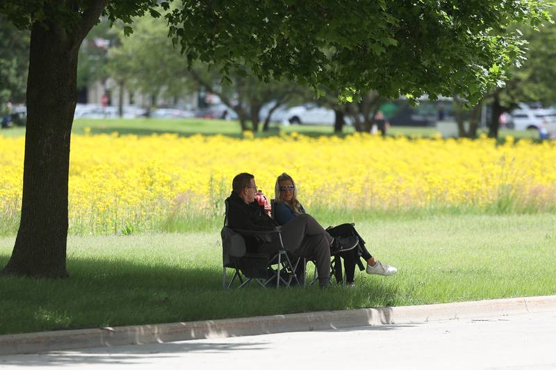 Mark and Dana McNally find a shade under a tree along the parade route at Plainfield’s Memorial Day and Ceremony event on Monday, May 27, 2024.