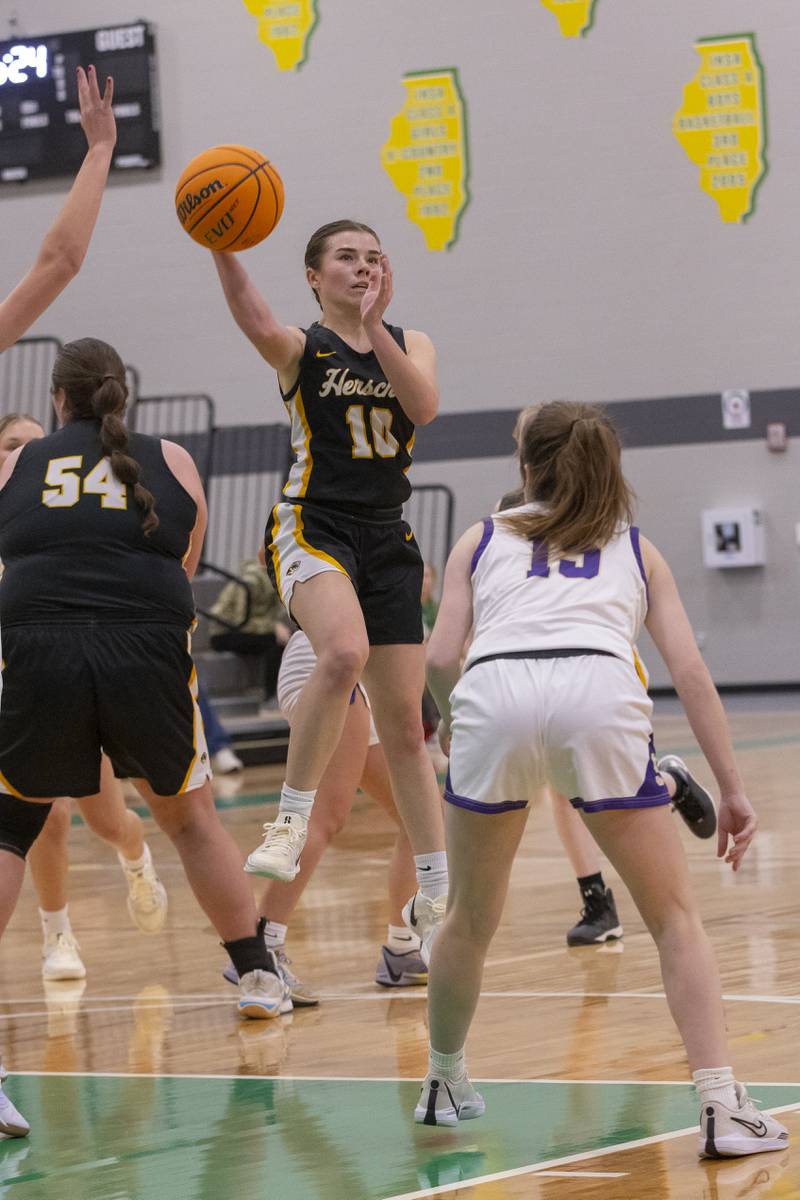 RyLyn Adams of Herscher High School jump passes the ball to a teammate during the Falcon-Irish Girls Basketball Tournament on November 19, 2024 at Seneca High School.