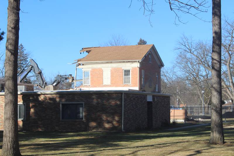 Excavators hack away at the Academy Building, built in the 1850s, on the St. Mary's Episcopal Church property in Crystal Lake on Jan. 13, 2026.