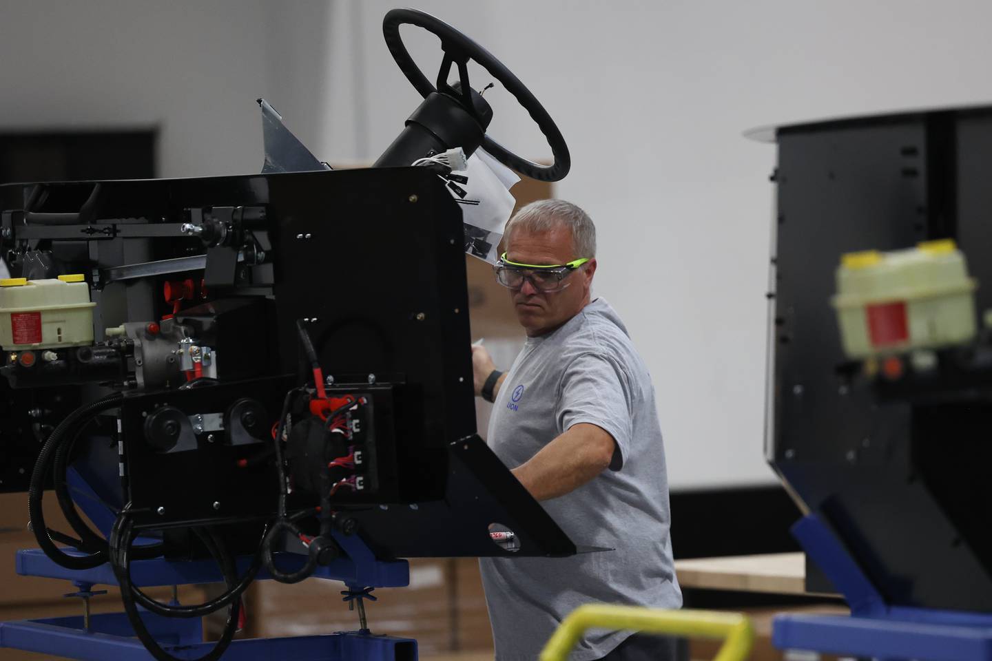 A mechanic works on the steering dashboard assembly at the Lion Electric manufacturing facility on Friday, July 21st, 2023 in Joliet.