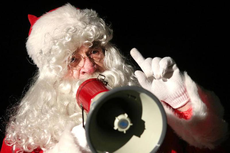 Santa Claus counts down to the lighting of the tree outside the Egyptian Theatre during the Lights on Lincoln and Santa Comes Thru Town event Friday hosted by the DeKalb Chamber of Commerce.