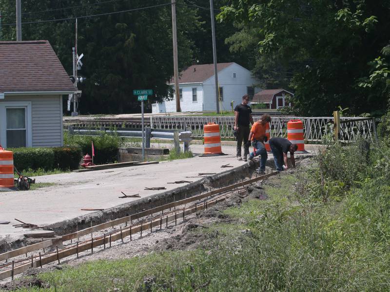 Crews prepare to pour a new sidewalk at the site of the Utica retail plaza on Monday, July 15, 2024 near the intersection of Mill and Grove Streets. Workers poured a sidewalk and have started the preliminary work on the Market on Mill area. The project is scheduled to be completed just before Burgoo.